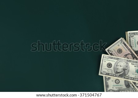 Dollar banknotes on dark background