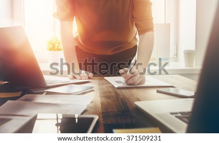 Close up business woman signing documents. Royalty-Free Stock Photo #371509231