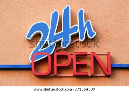 24 hours open sign on a wall