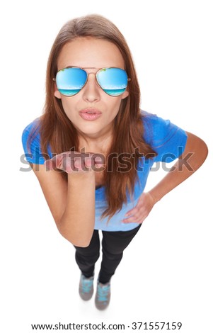 Holidays, travel, vacation concept. Full length woman in sunglasses with tropical resort ocean reflection blowing a kiss at camera