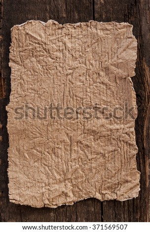 Grunge paper on wooden background