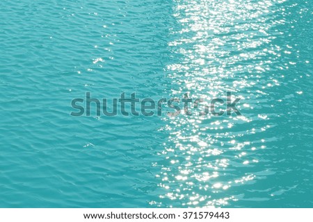 Reflective light on water surface as blurred vintage background