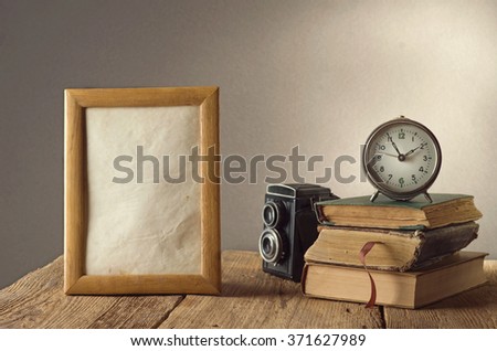 Still life with black vintage clock and photo frames