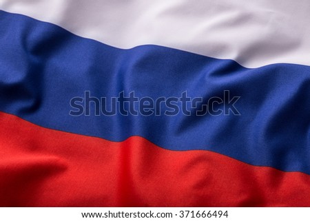 Colorful Russia flag waving in the wind.  Royalty-Free Stock Photo #371666494