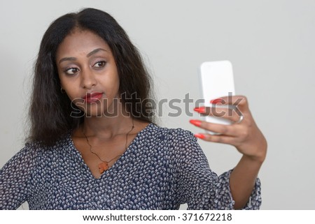 Beautiful African woman taking selfie