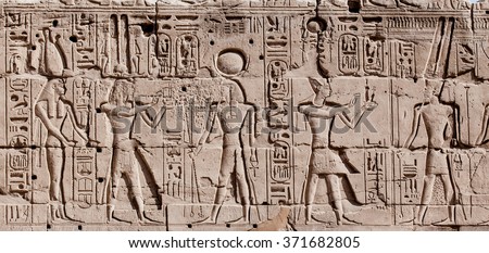 Egyptian hieroglyphs. Hieroglyphic carvings on a wall Royalty-Free Stock Photo #371682805