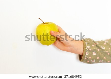 Child hand holding an apple