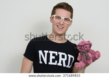 Nerd holding teddy bear
