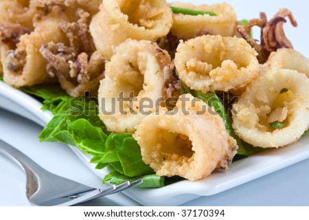 deep fried calamari with salad and butter sauce Royalty-Free Stock Photo #37170394