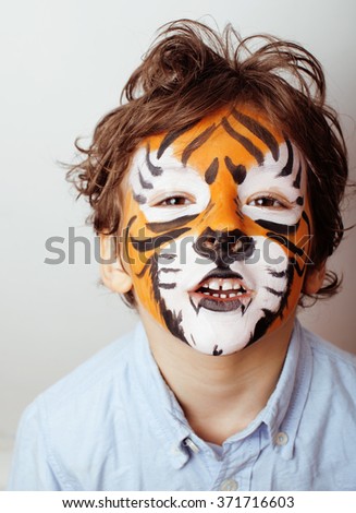 little cute boy with faceart on birthday party close up, little cute tiger