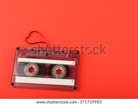 Vintage audio cassette with loose tape shaping a heart
