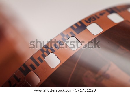 Close-up of 35 mm photographic film at the blurred background