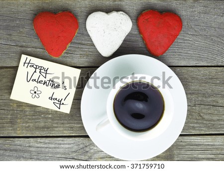 Romantic breakfast. Cup of coffee, heart shape cookies,note for text. Happy Valentine's Day message Toned image