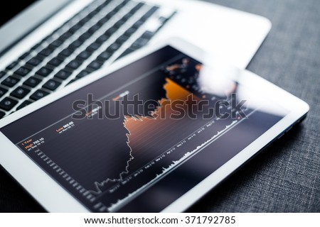 Stock market chart digital tablet Royalty-Free Stock Photo #371792785
