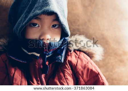 Asian boy with coats ,vintage filter 