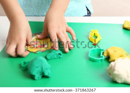 Child sculpts from plasticine, closeup