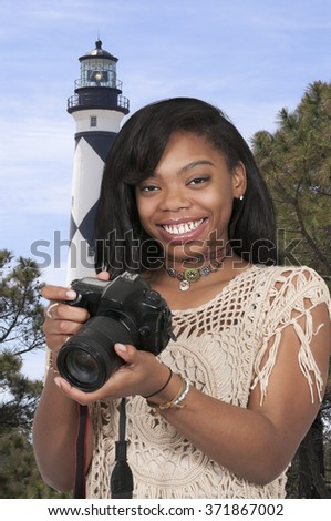 Young woman photographer with her dslr camera