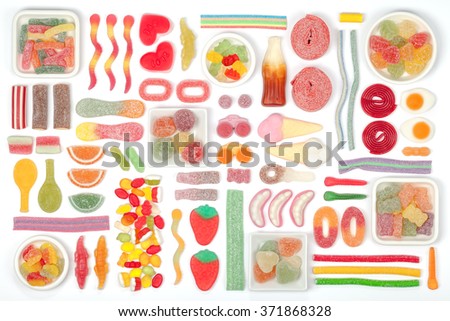various jelly candies on white background. multicolored flat lay composition