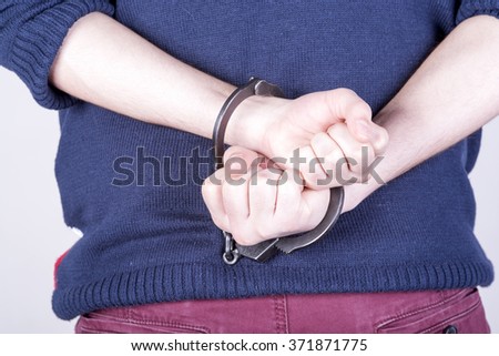 a picture of the offender in handcuffs