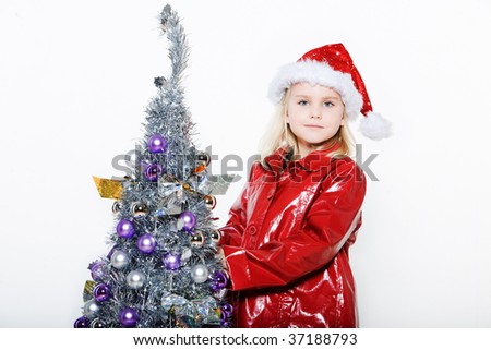 indoors picture of a little girl preparing christmas tree on isolated white background