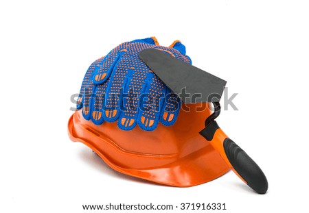 Construction helmet with steel trowel and gloves on white