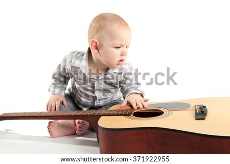 Cute baby with guitar isolated on white background