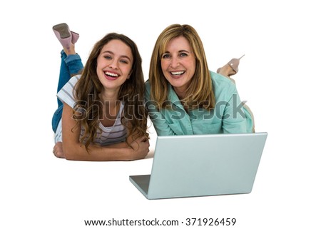 Mother and daughter watch computer lying on the ground