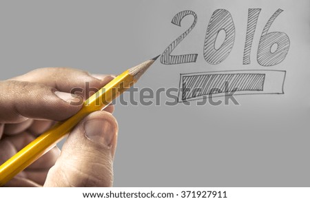 yellow Pencil in man's hand Isolated on white background. Male fingers writing 2016 for celebrate happy new year