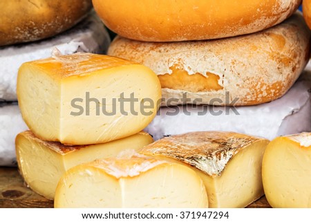 Cheese on a traditional craftsman market.Horizontal image. Royalty-Free Stock Photo #371947294