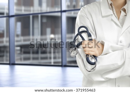 blurred background of city landscape with big blue window and floor with doctor hands 