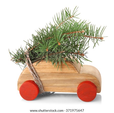 Wooden toy car with fir sprigs, isolated on white