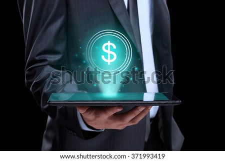 Businessman holding tablet with a projected on-screen icon online trading dollar. business Internet concept.