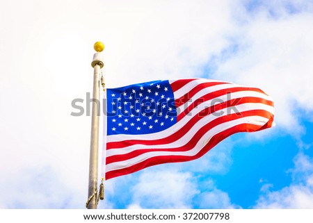 American flag on blue sky