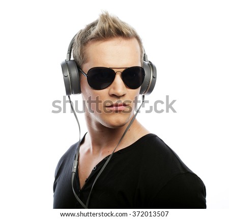 Happy young man listening to music with headphones 