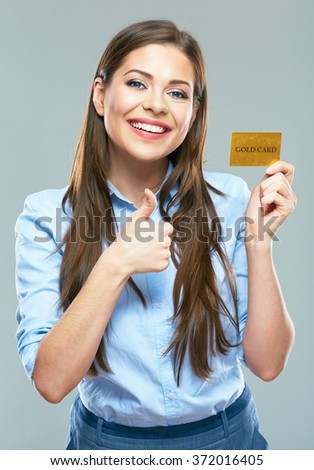 Happy smiling business woman holding credit card show thumb up. isolated studio portrait.
