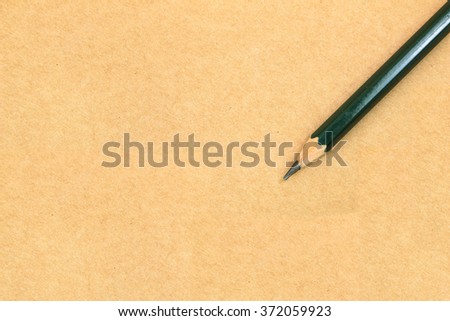 Pencil on brown paper texture background