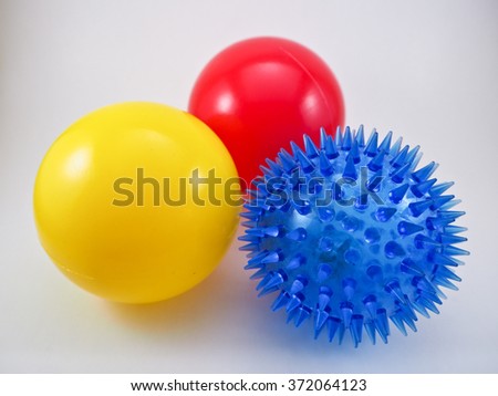 a yellow plastic ball, red plastic ball and blue rubber ball that children love to play.