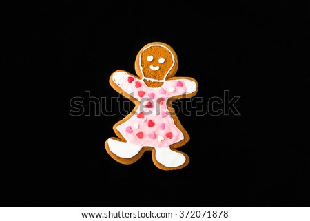 Gingerbread man, woman, on black velvet in christmas