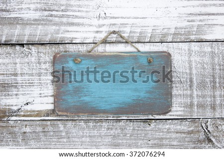 Blank wood teal blue sign hanging on antique rustic white wooden background; painted background with copy space