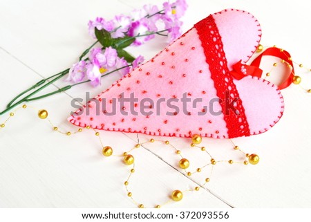 Handmade pink felt heart with beads and red lace 