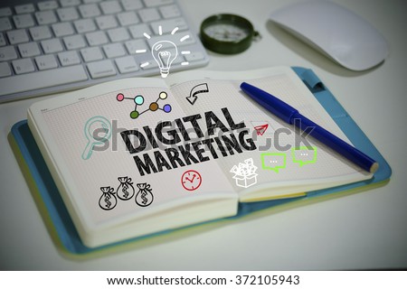 drawing DIGITAL MARKETING  concept on notebook in the office , business concept , business idea 