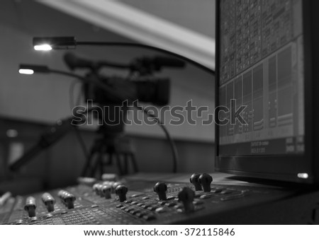 Professional digital video camera. accessories for 4k video cameras. tv camera in a concert hall. 
black and white photo