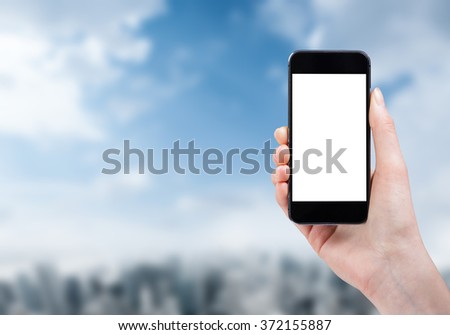 woman hand holding a phone on a city background with isolated screen