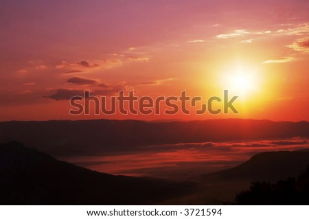 Mountain silhouette and fog on sunset