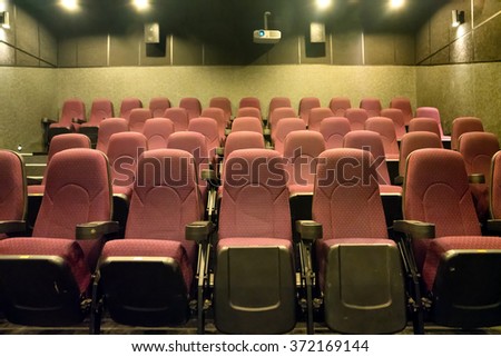 Empty seats in the small movie theater with cinema projector