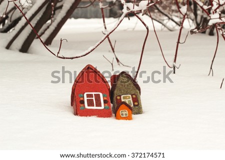 Toy houses on snow
