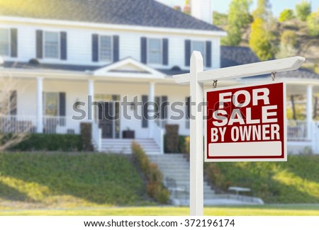 For Sale By Owner Real Estate Sign and Beautiful House.
