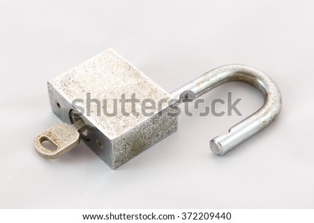 Old master key rusty and key lock on white background Royalty-Free Stock Photo #372209440