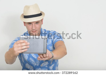Tourist photographer taking picture with digital tablet