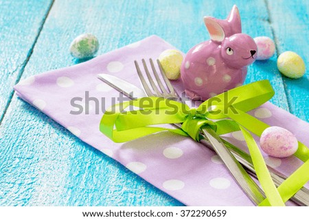Colorful Easter eggs and Easter rabbits on a wooden table